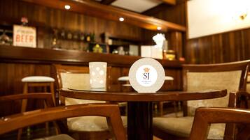 A bar area with wooden furniture and a sign reading "PRESERVE BEER".