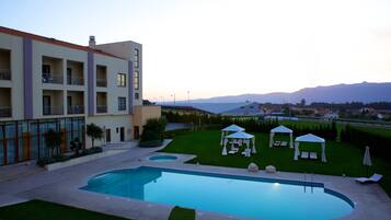 Relax by the pool surrounded by lush greenery and scenic views.