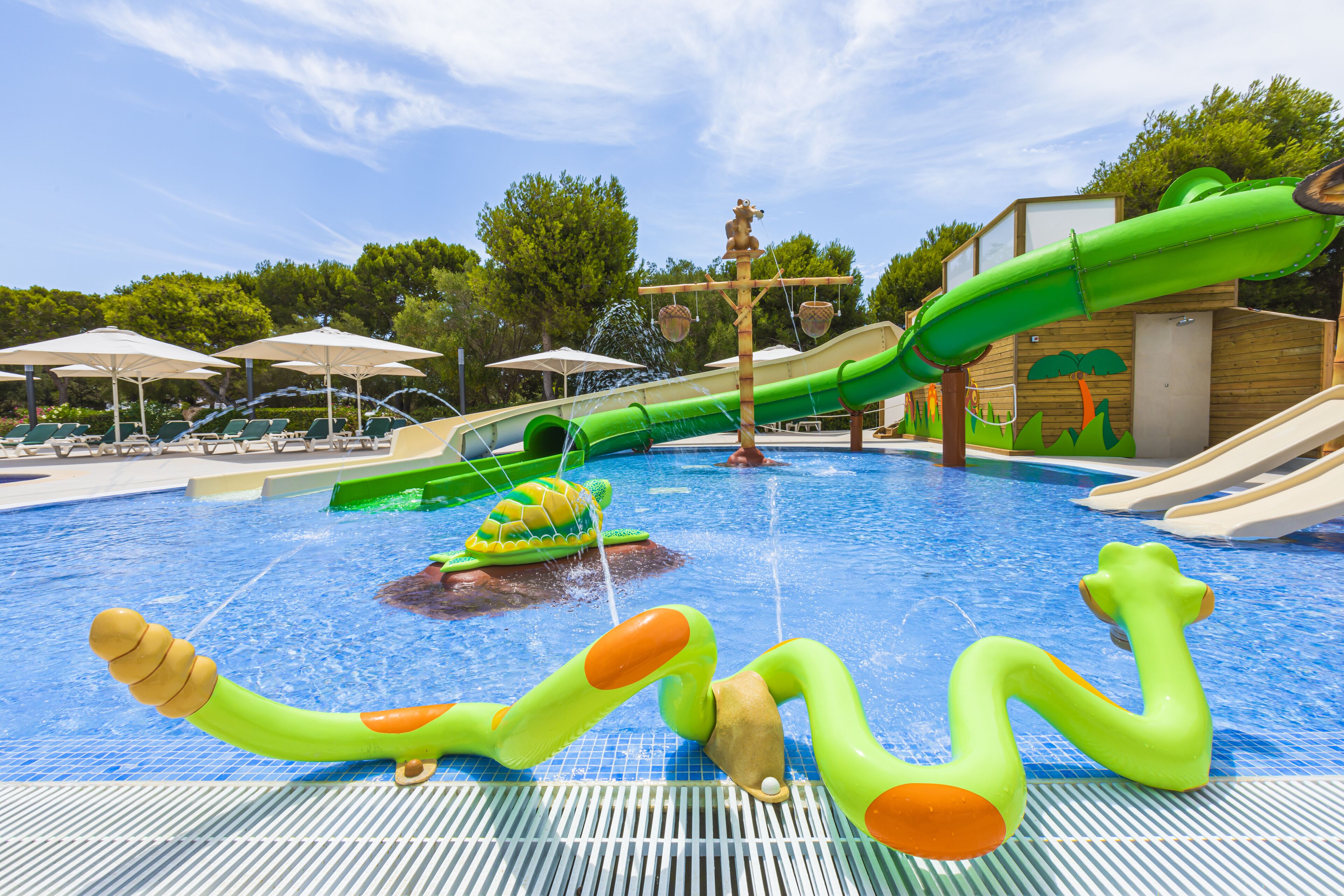 A swimming pool with slides and inflatable toys.