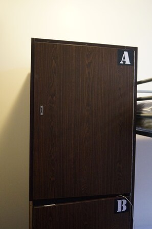A wooden double-door refrigerator with a handle and a lock, marked with letters A and B. - 790 on George Backpackers (Haymarket)