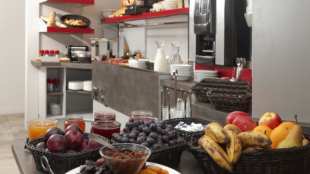 A buffet setup with various fruits, pastries, and beverages. - La Table de Gustave (Ornans)