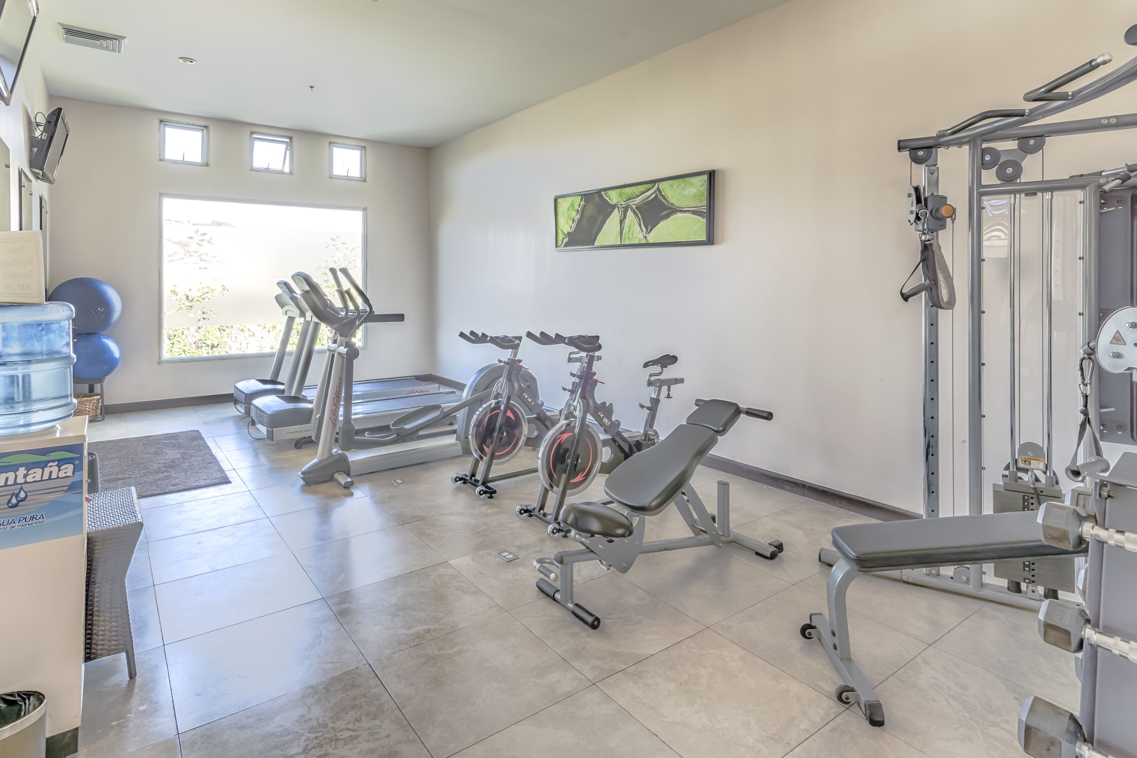A gym with treadmills, stationary bikes, and weight machines.