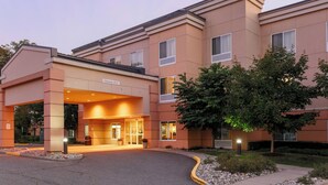 A hotel entrance with a clear entrance, a reception desk, and a sign indicating a 14-gallon capacity. - Fairfield Inn & Suites Mahwah (Mahwah)