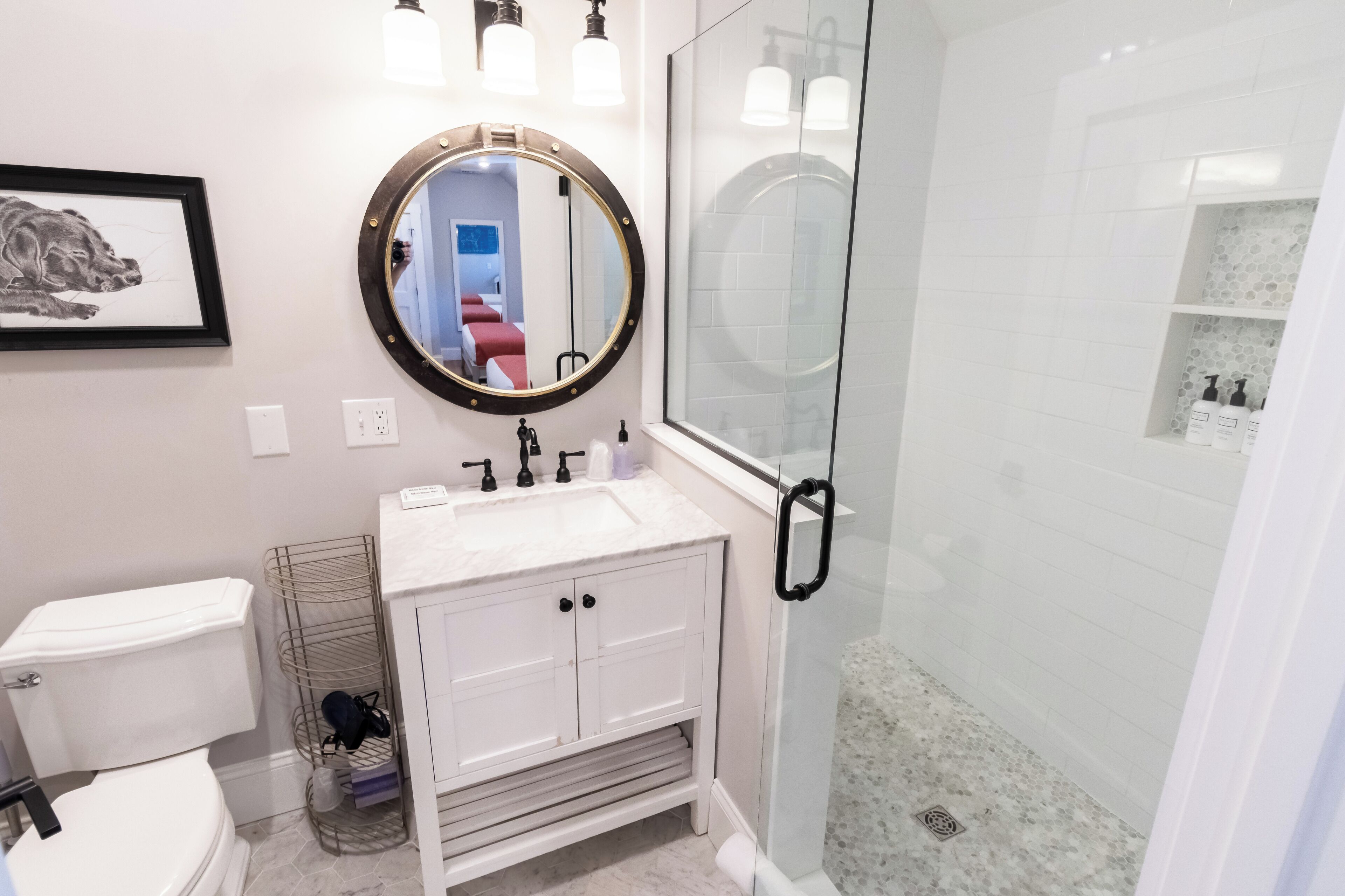 A bathroom with a toilet, sink, and shower.