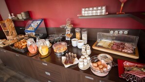 Un bufé de desayuno con diversos alimentos y utensilios.