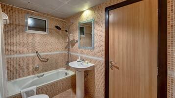 A bathroom with a bathtub, sink, and toilet.