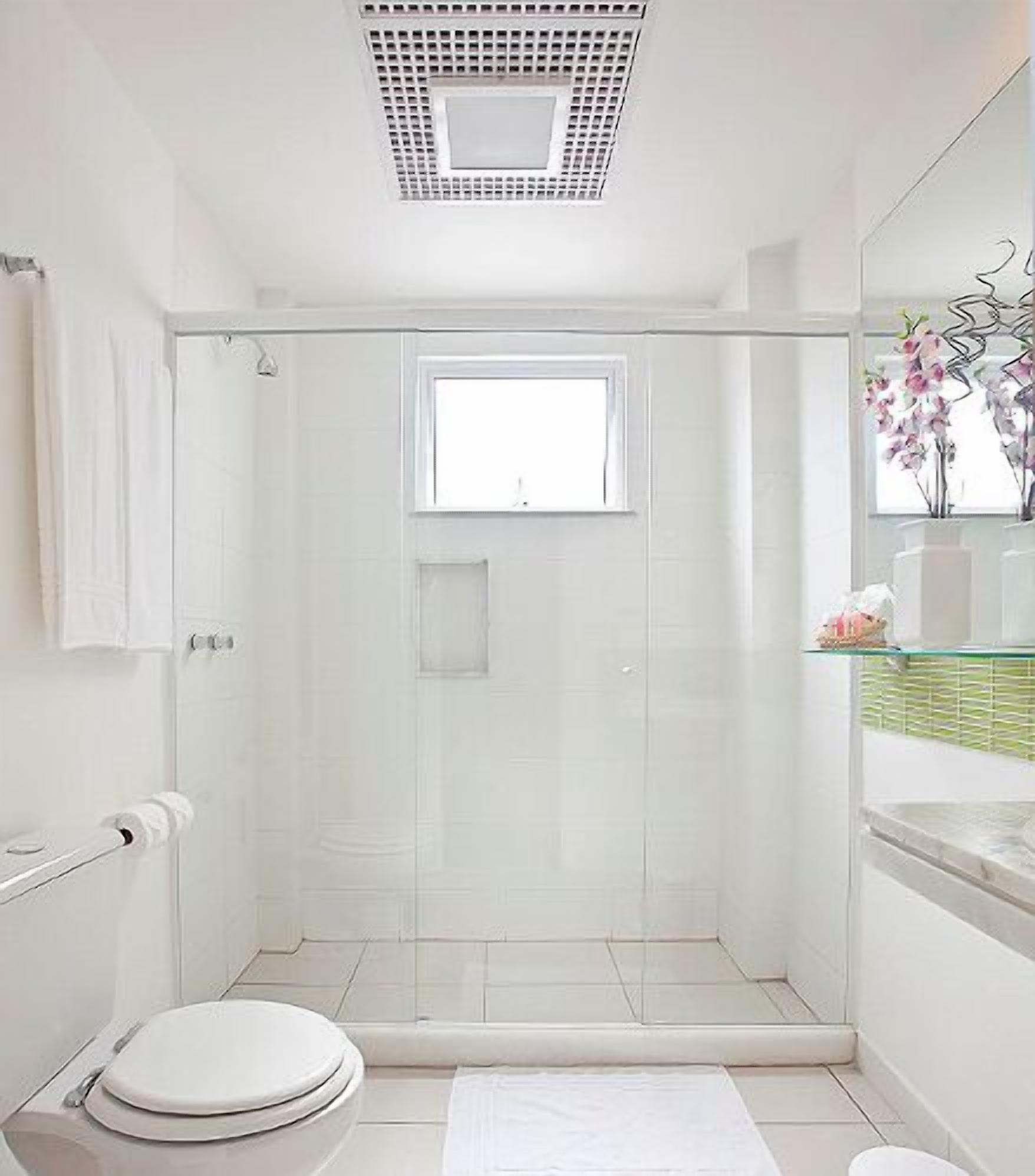 A modern bathroom with a glass-enclosed shower, a toilet, and a sink with a mirror above it.
