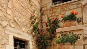 A stone staircase with potted plants at each landing. - Strofilia Villas (Apokoronas)