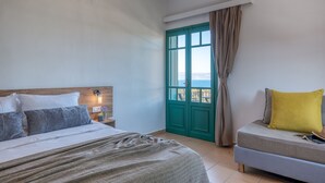 A bedroom with a bed, a nightstand, a window with curtains, and a view of the outside. - Kaliviani Traditional Hotel (Kissamos)