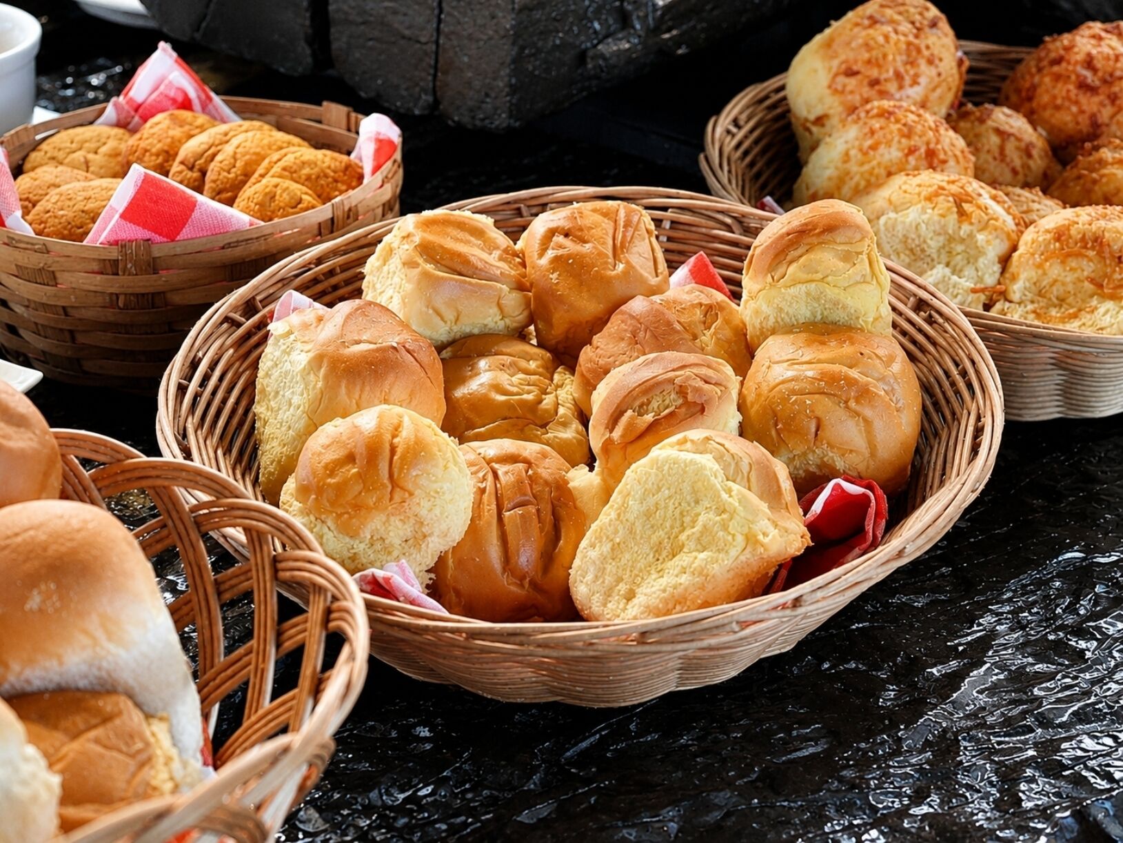 A variety of baked goods in wicker baskets.