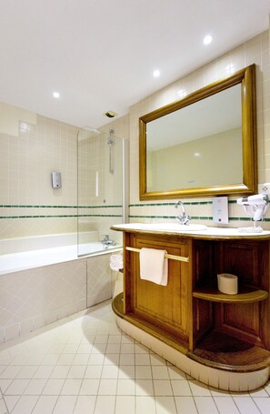 Bathroom features a large mirror, sink, and glass-enclosed shower.
