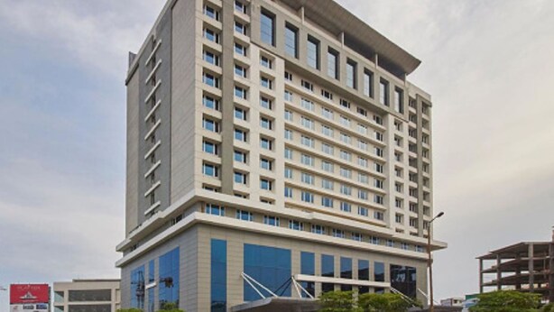 A multi-story hotel with a modern design, featuring a prominent entrance and a large glass facade. - Radisson Hyderabad Hitec City (Hyderabad)
