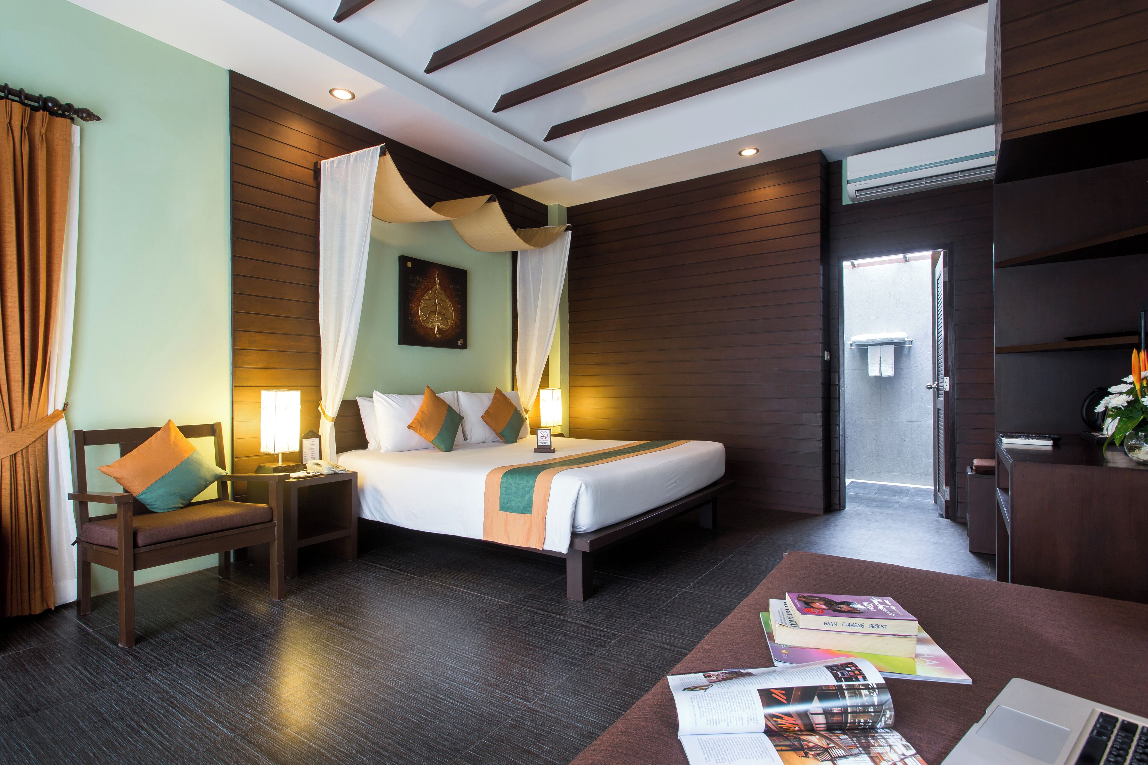 Ein Hotelzimmer mit Bett, Nachttischen, Schreibtisch und Stuhl.
