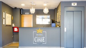 A hotel reception desk with a sign reading "HOTEL CONDE by Sorotel hotels."