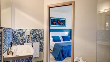 A hotel bathroom with a sink, towel rack, and a mirror.