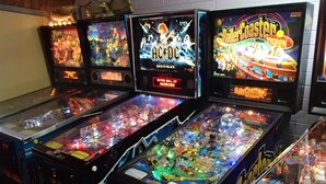 A row of arcade-style pinball machines with various designs and themes. - Nhill Oasis Motel (Nhill)
