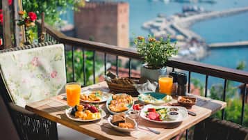 Enjoy a leisurely breakfast on the balcony with a view of the water and cityscape.