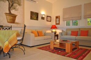 Suite Cottage Les Oliviers | Coin séjour | Télévision à écran plat, lecteur de DVD