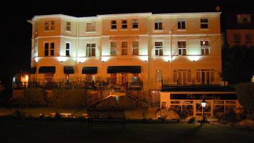 Vista frontal de la propiedad por la tarde o noche