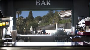 A bar with a view of a residential area and a fence. - Summer Hotel (Calella)