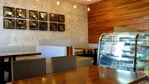 Ein Restaurantinneres mit Tresen, Sitzbereich und Wanddekoration.