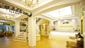 A hotel lobby with a grand staircase, a reception desk, and a chandelier. - Mirador Hotel Kaohsiung (Kaohsiung)