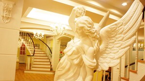 A staircase with a white statue of an angel at the top. - Mirador Hotel Kaohsiung (Kaohsiung)