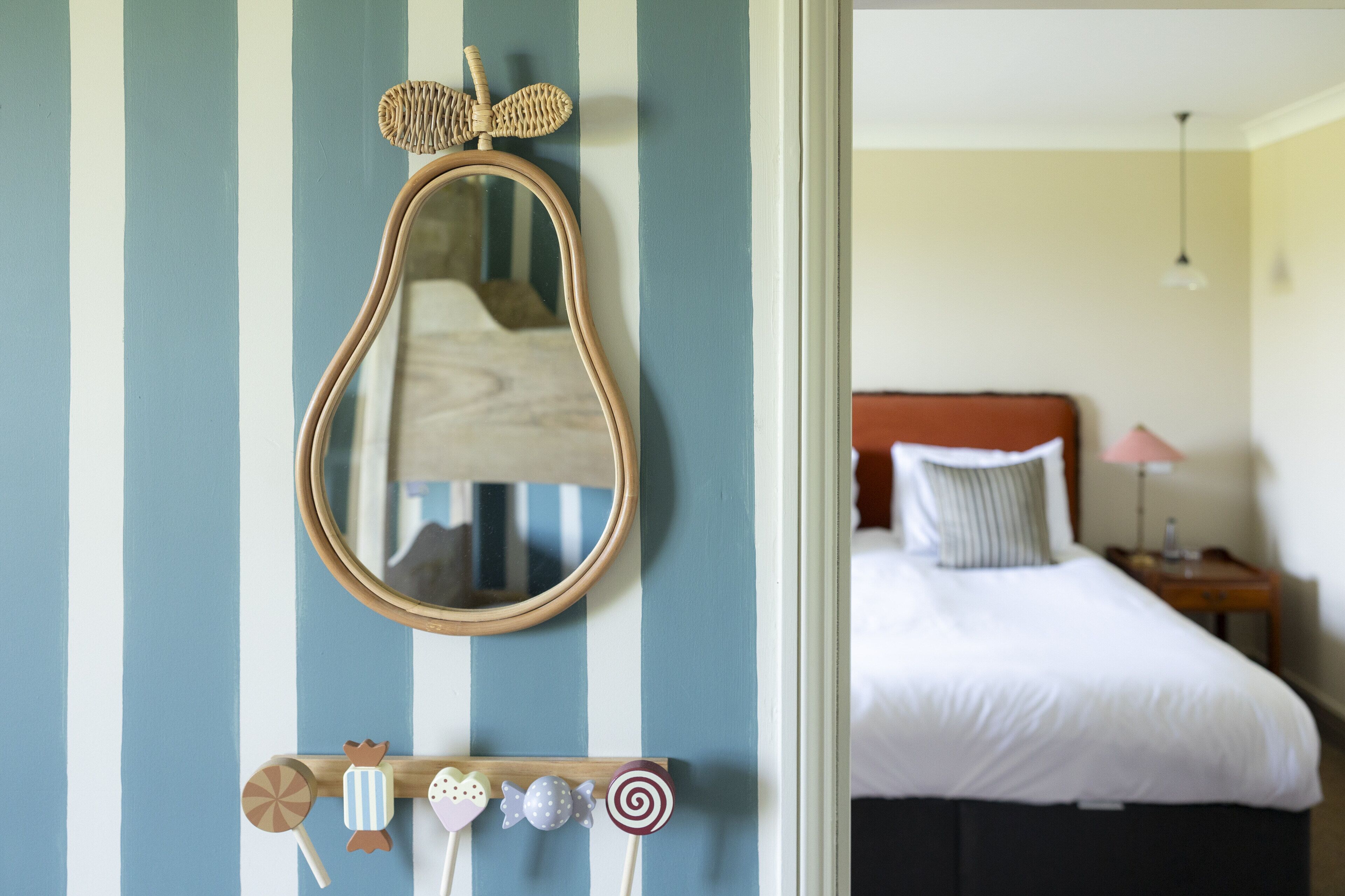 A bedroom with a bed, a bedside table, and a nightstand.
