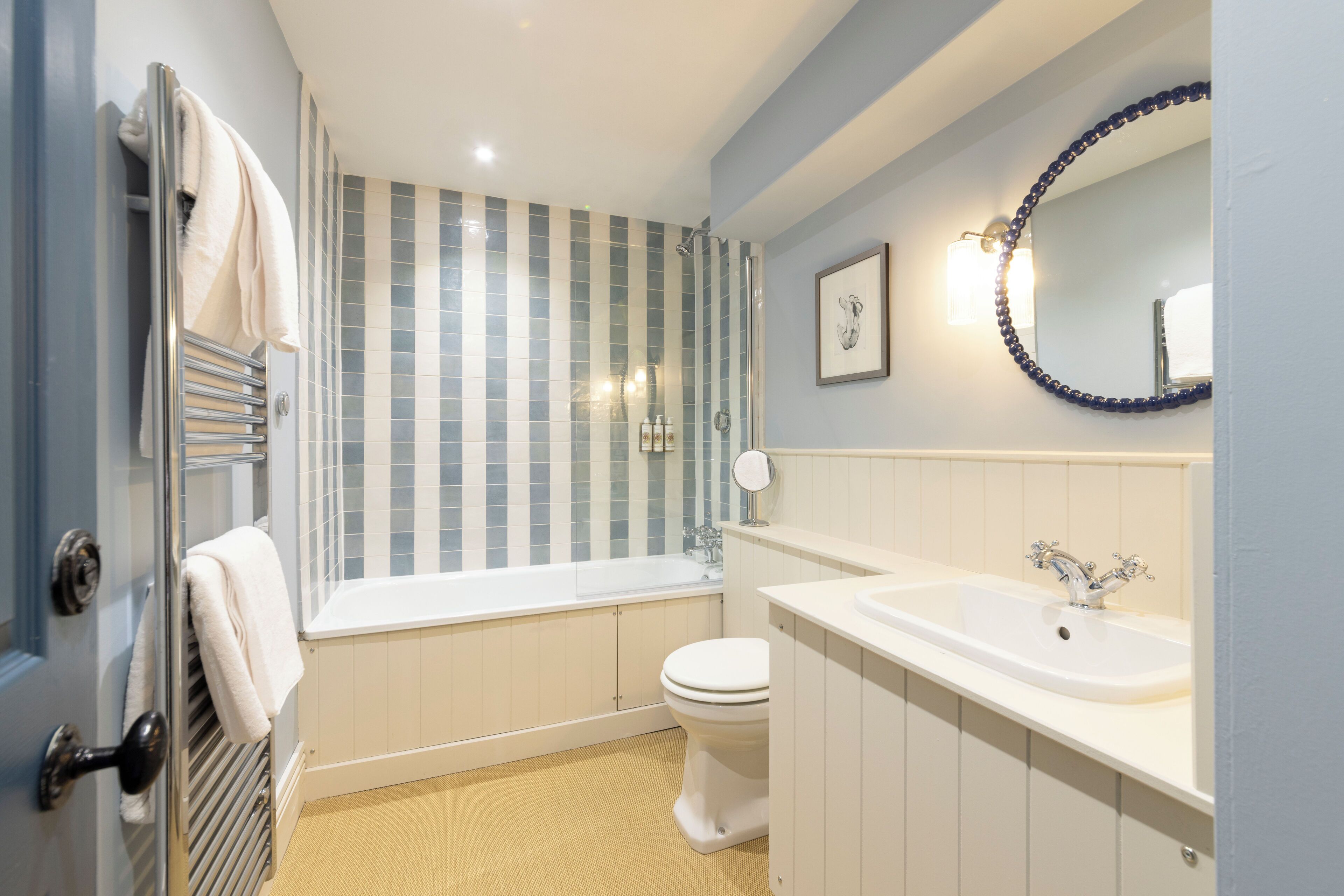 combined shower/bathtub, designer toiletries, hair dryer, towels