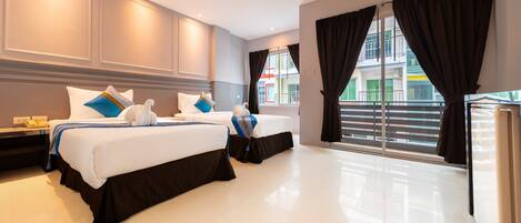 A hotel room with two beds, a large window with curtains, and a view of the outside.
