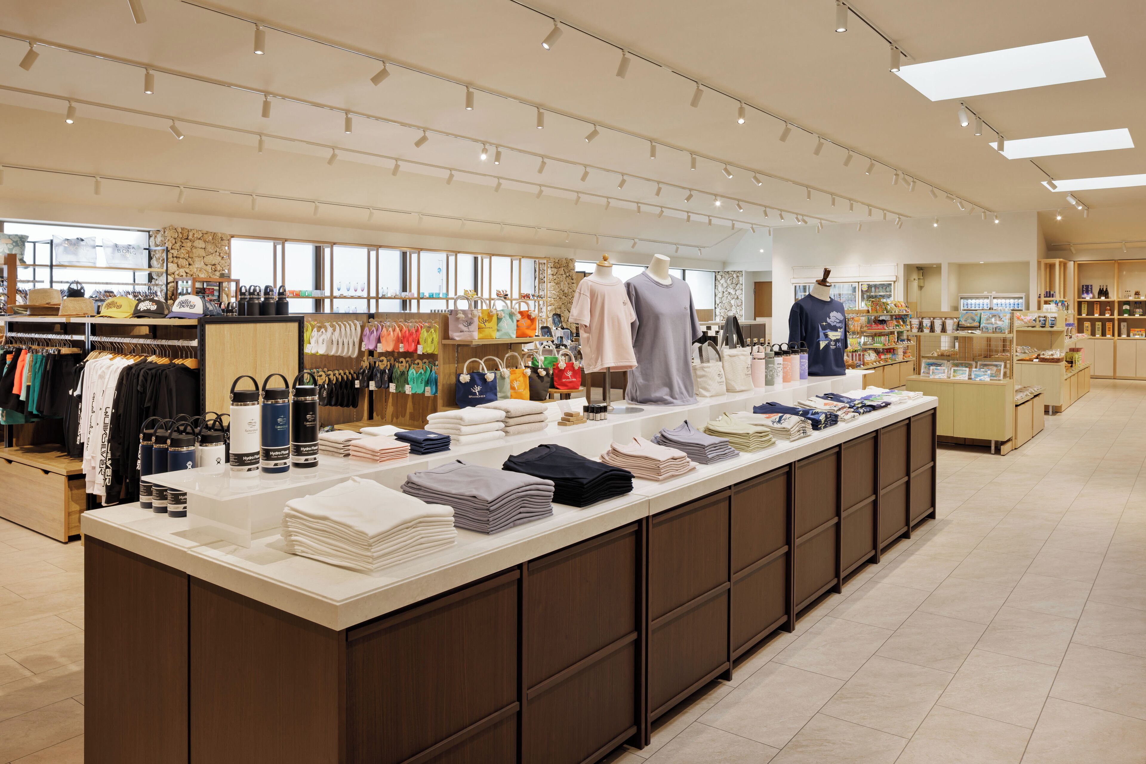 A well-lit retail store with neatly arranged clothing and accessories on shelves and counters.