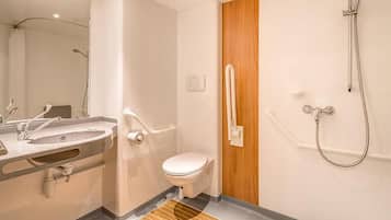A modern bathroom with a sink, toilet, and shower.