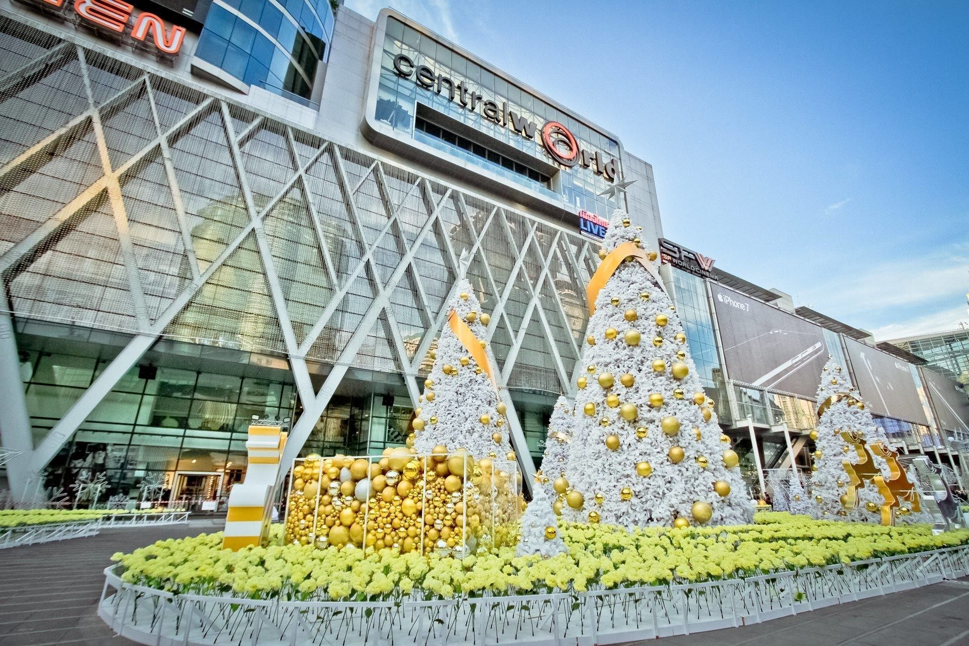 A modern building with a glass facade and a large sign reading "Central World".