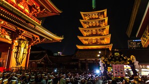 A traditional multi-tiered pagoda with illuminated tiers, surrounded by a crowd of people. - Residential Hotel B:CONTE Asakusa (Tokyo)