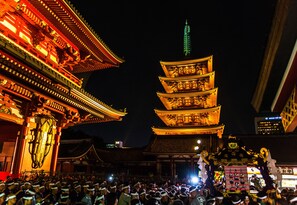 A traditional multi-tiered pagoda with illuminated tiers, surrounded by a crowd of people. - Residential Hotel B:CONTE Asakusa (Tokyo)