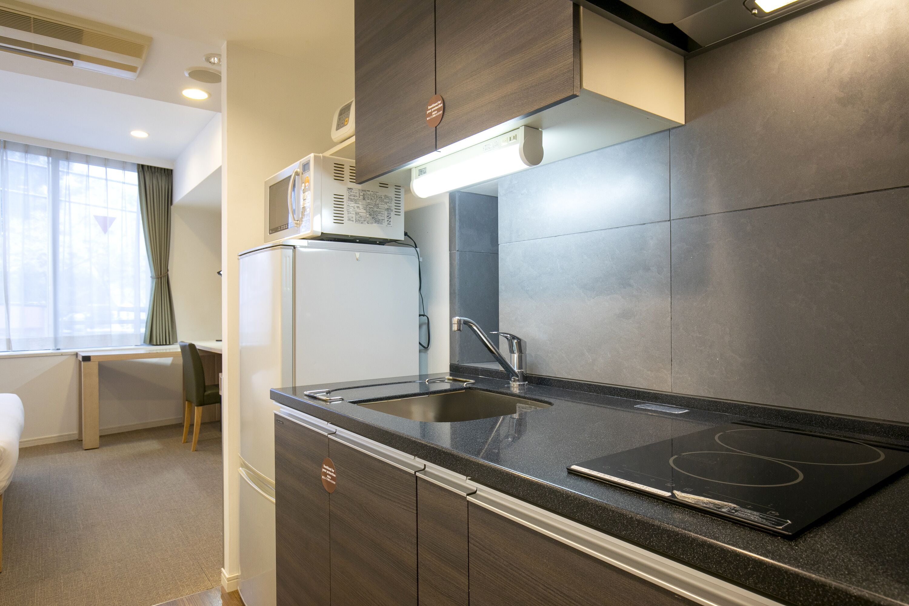 full-sized fridge, microwave, stovetop, espresso maker