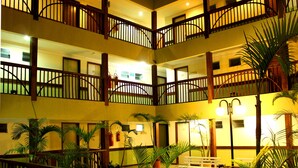 A multi-level atrium with a tiled floor, wooden railings, and potted plants. - Natal Praia Hotel (Natal)