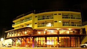 A multi-story hotel with a ground-level restaurant and upper residential balconies. - Natal Praia Hotel (Natal)