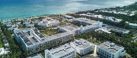 A resort with multiple buildings, a pool, and a beach.