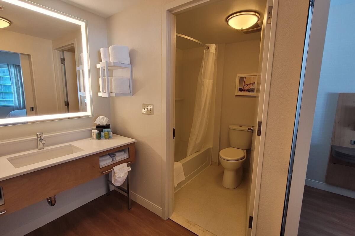 designer toiletries, hair dryer, towels, soap