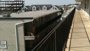A bridge with a metal railing, a Coca-Cola vending machine, and a sign for the Glendale Motel. - Glendale Motel (Seaside Heights)
