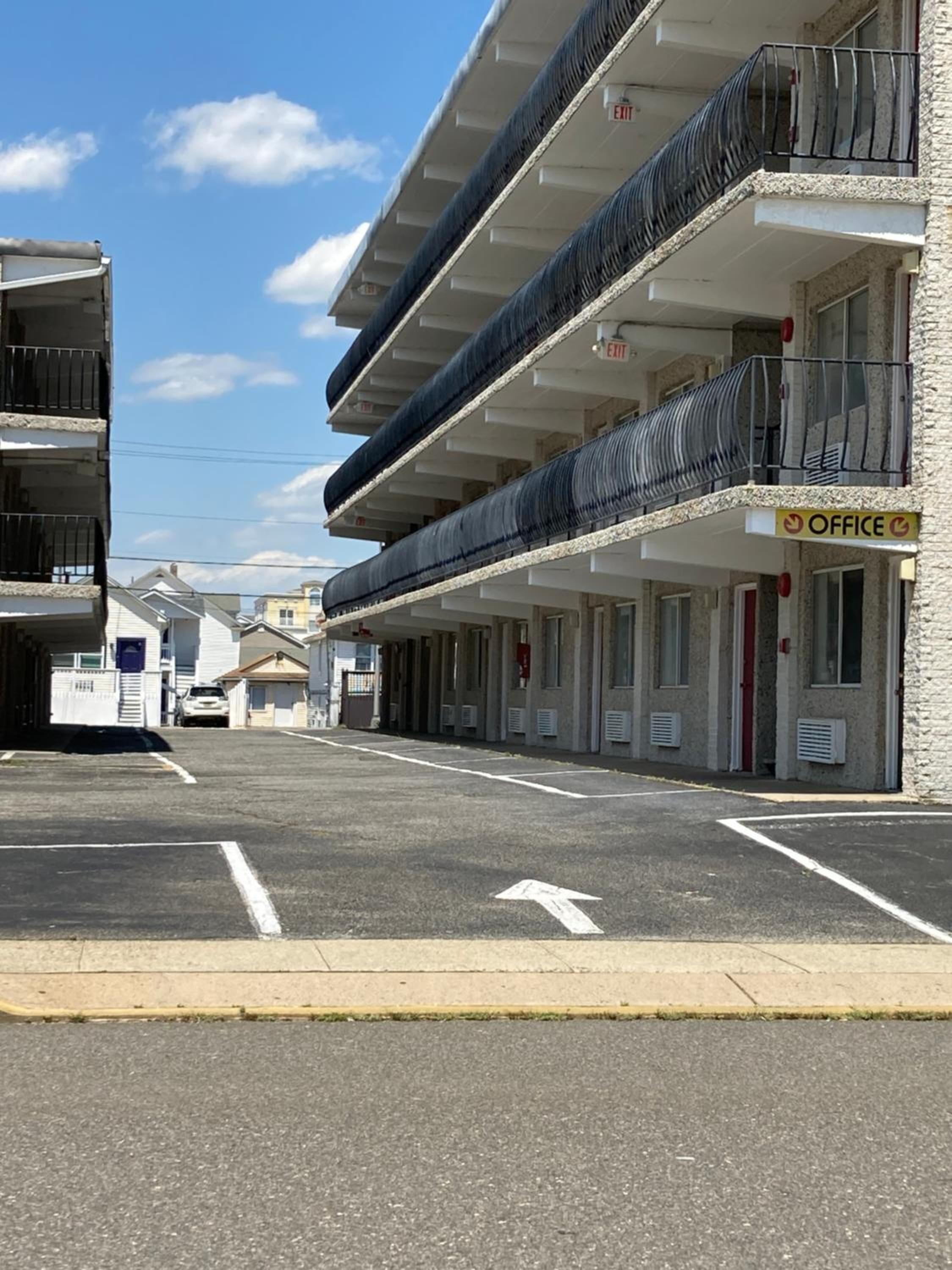 A multi-story building with a row of office spaces on the ground floor, marked by an 'OFFICE' sign.
