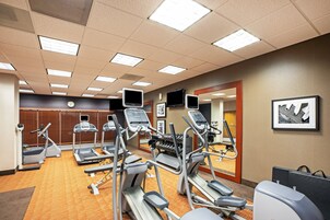 A gym with treadmills, elliptical machines, and stationary bikes.