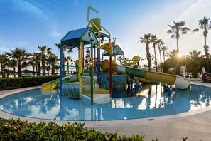 A water park with a play structure and a pool.