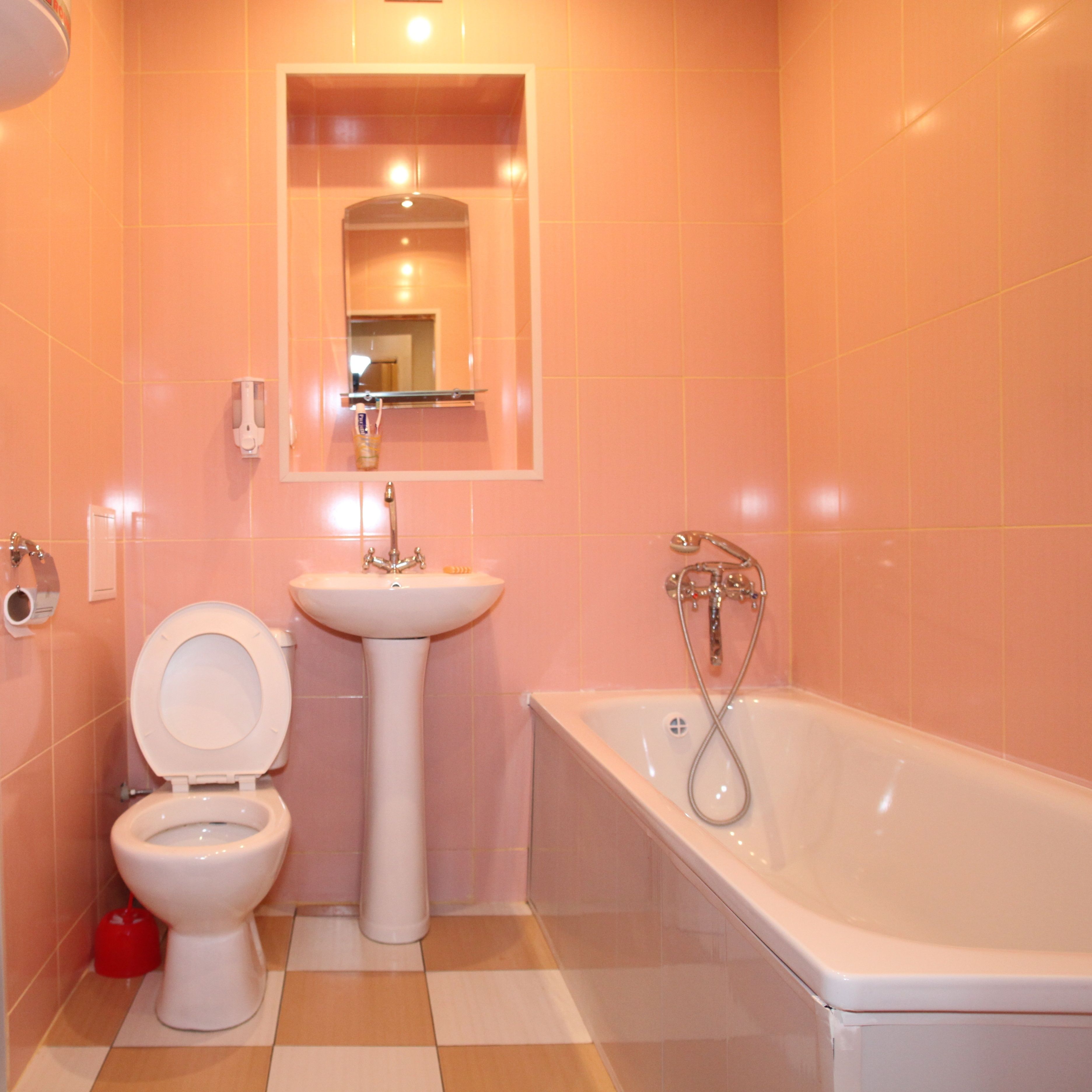 A bathroom with a toilet, sink, and bathtub.