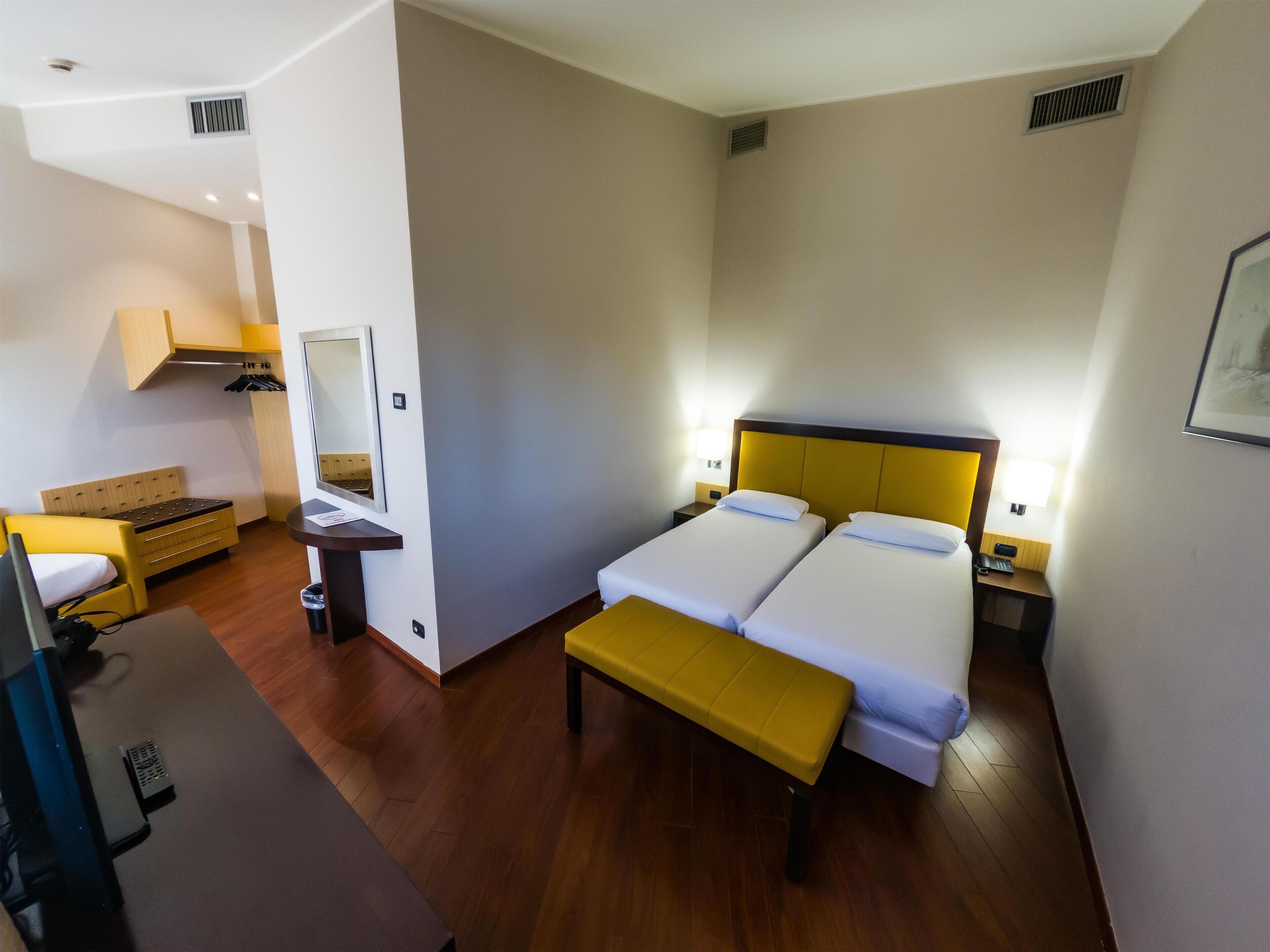 Standard Triple Room | Minibar, in-room safe, desk, blackout drapes