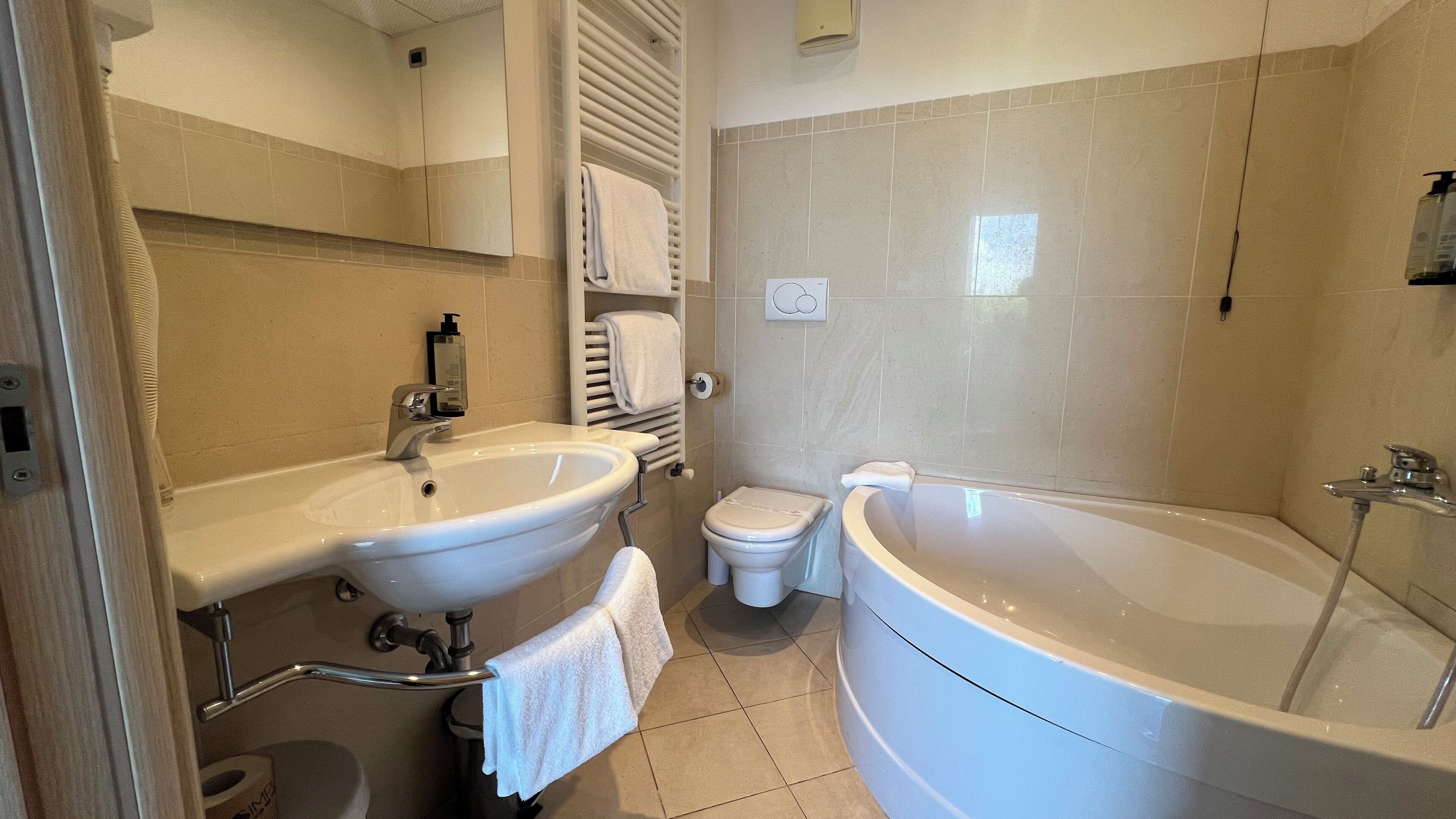 A bathroom with a sink, toilet, and bathtub.