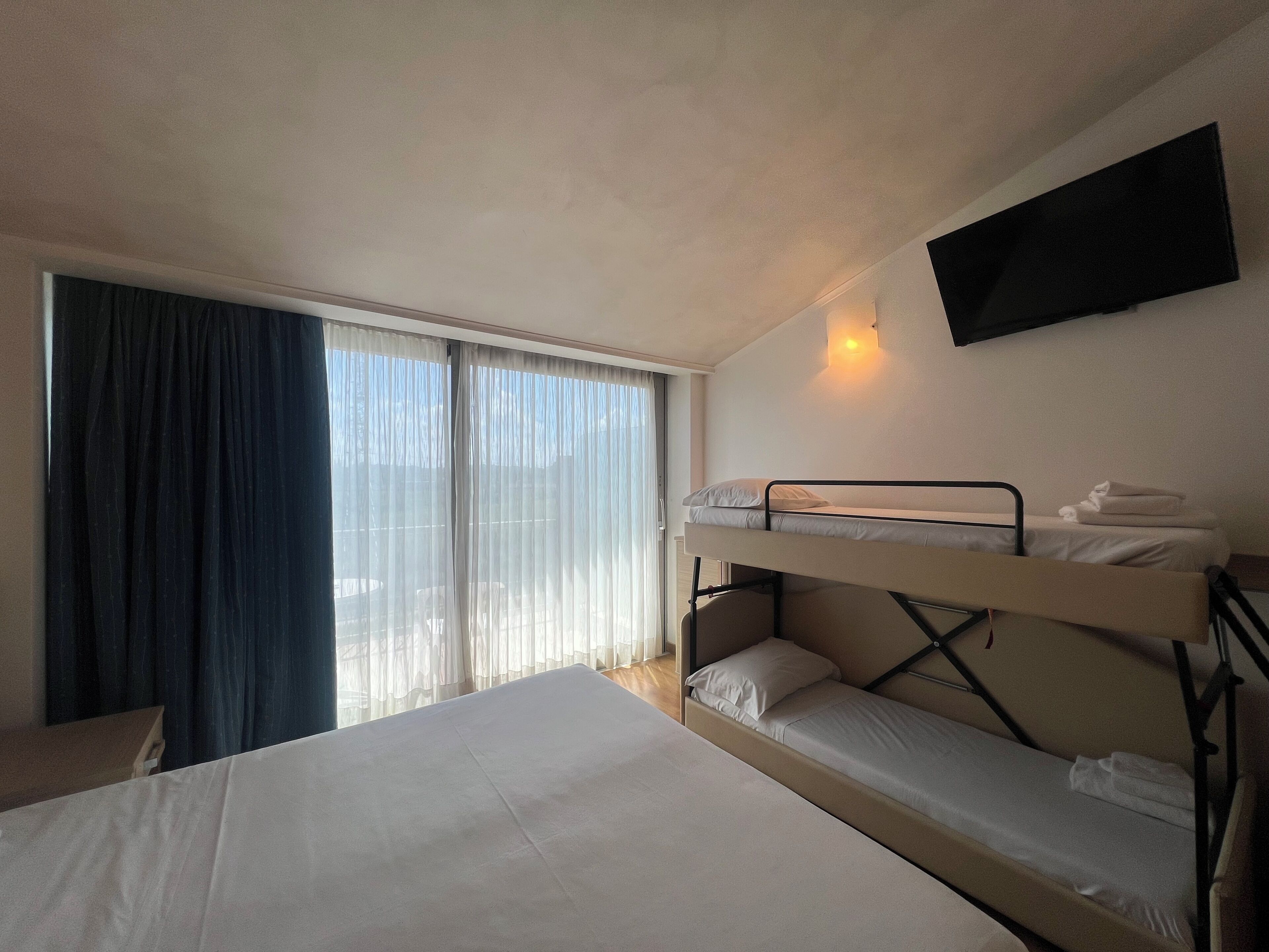 Classic Quadruple Room | Minibar, in-room safe, desk, laptop workspace