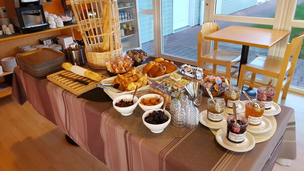 A breakfast buffet with various pastries, bread, and condiments. - The Originals Access, Hôtel St Flour (Andelat)