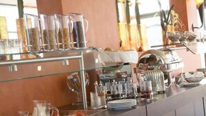 A buffet area with various food items and beverages.